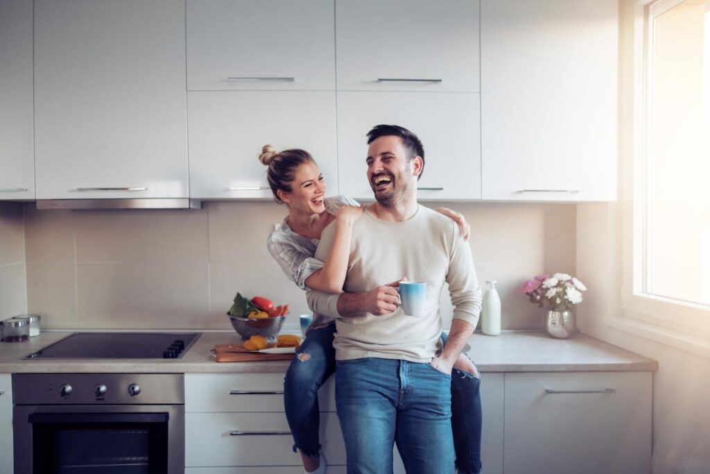 couple playing in kitchen